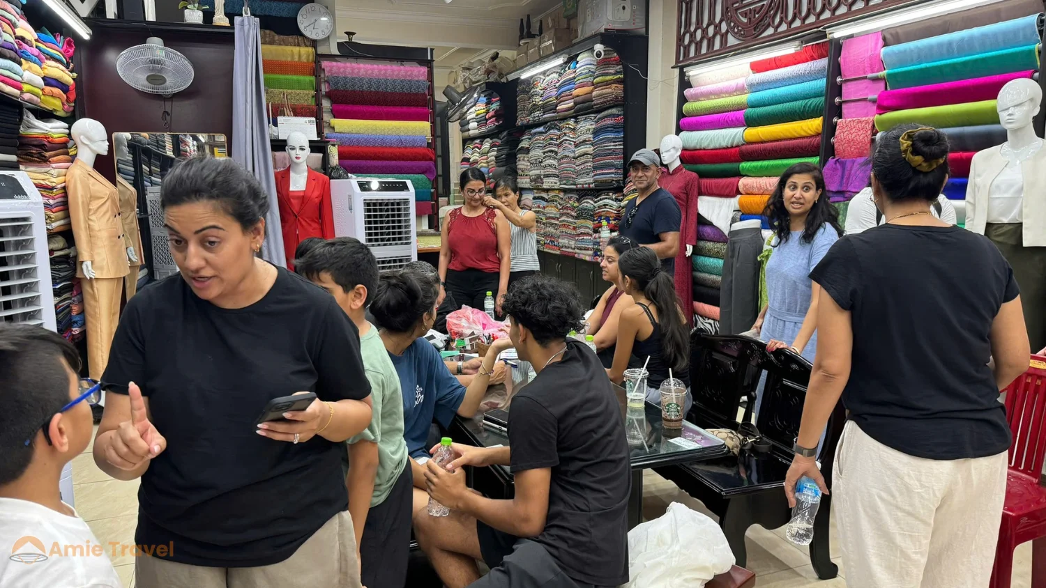 Hoi An tailor shop interior fabrics fitting covered rainy season activity